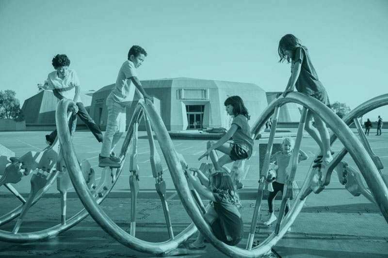 Children playing on the DNA sculpture at the Lawrence