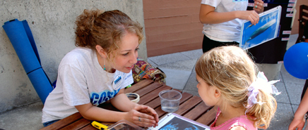 An adult and child are talking together about science