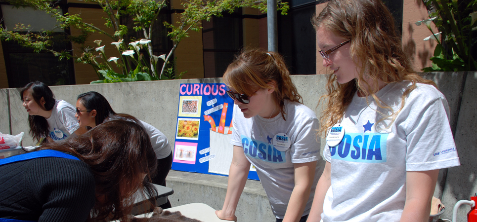 Two COSIA students at an informational outdoor event