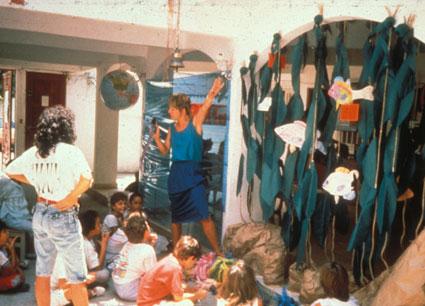 A group of students and their teachers in a classroom decorated for Ocean Immersions