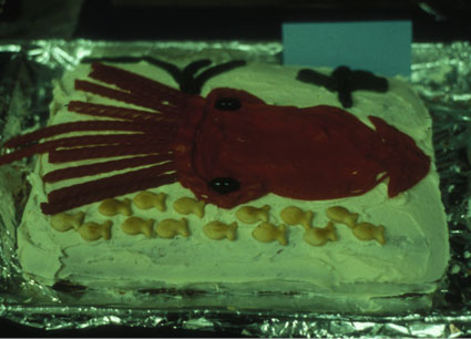 A cake decorated with a squid and fish for Ocean Immersions